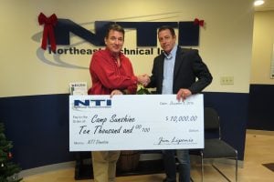 NTI President Jim Liponis (left), presents a donation of $10,000 to Michael Smith of Camp Sunshine